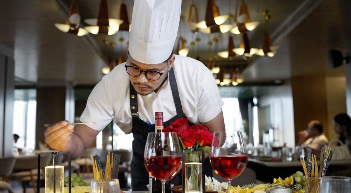 Chef plating a table at Hotel Palacio